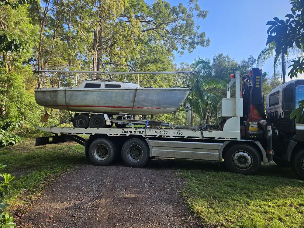 Boat carried on the tilt tray truck at a residential property