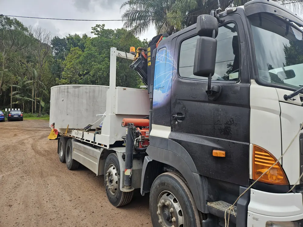 Large cylindrical tank loaded on the crane truck tray