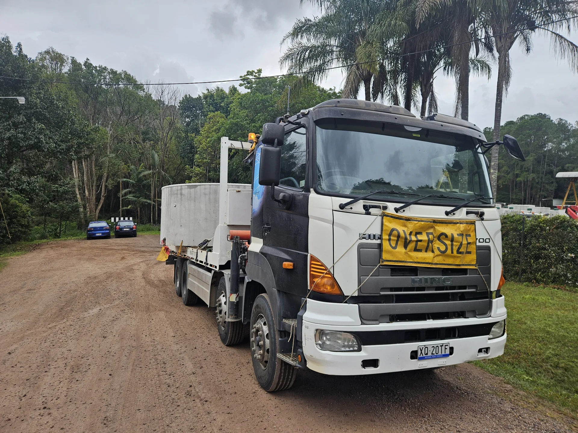 Crane & Tilt truck positioned on a rural access road