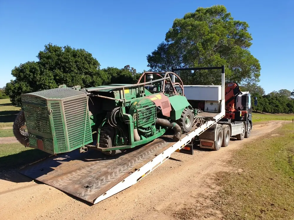 Large green machinery on tilt tray