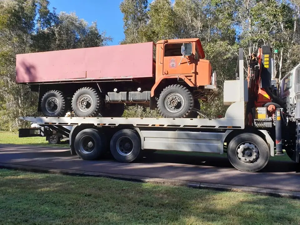 Red truck carried on tilt tray